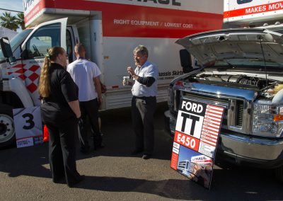 A man giving a demonstration about a U-Haul truck.