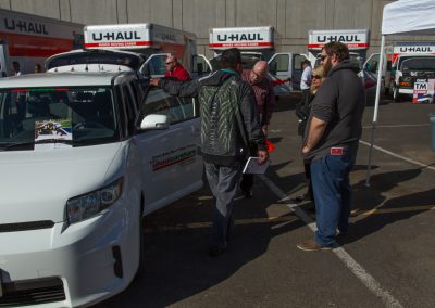 Several people viewing a U-Haul Car Share demonstration.