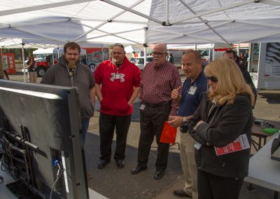 Five people watching a demonstration on screen.