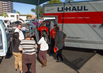 People viewing a U-Haul truck demonstration.