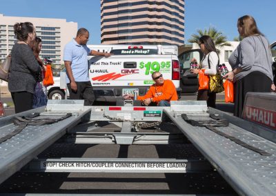 Four U-Haul employees receiving a trailer demonstration.