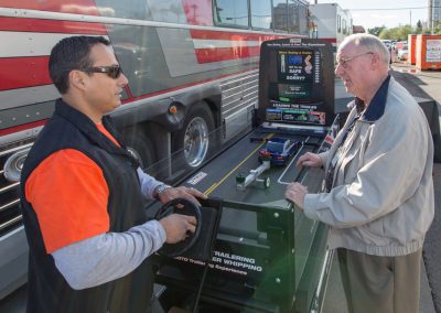 A man giving a safe trailer demonstration to another man.