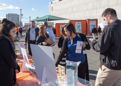 U-Haul employees interacting near a display table.