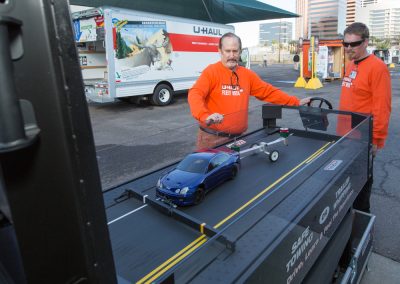 A man giving a safe trailering demonstration.