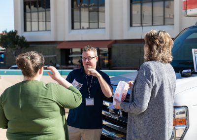 Three U-Haul employees talking.