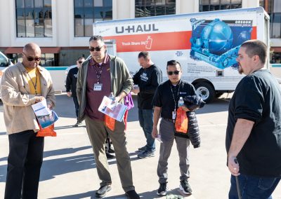 U-Haul employees standing near a U-Haul truck.