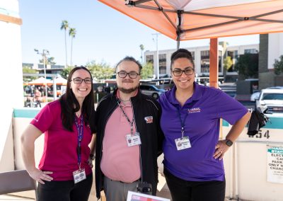 Three U-Haul employees posing at a booth.