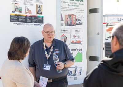 A man standing in front of a U-Box container.